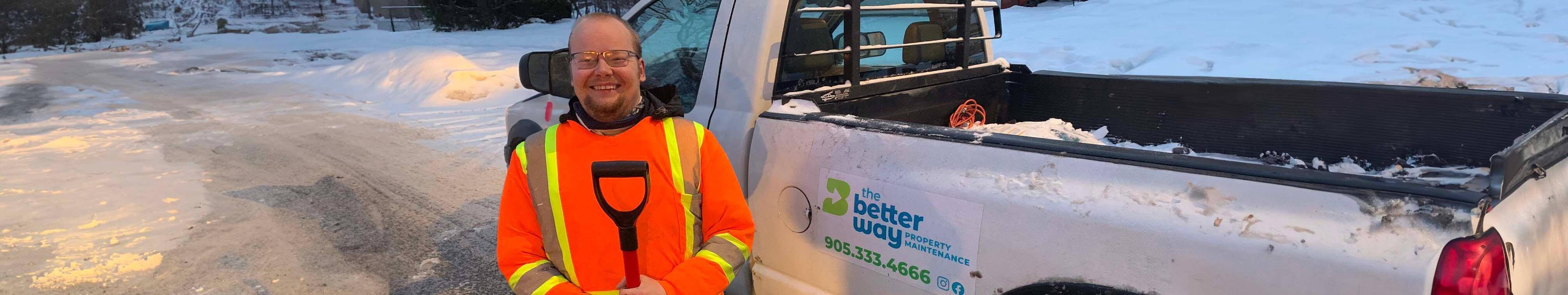 The Better Way team member holding snow shovel