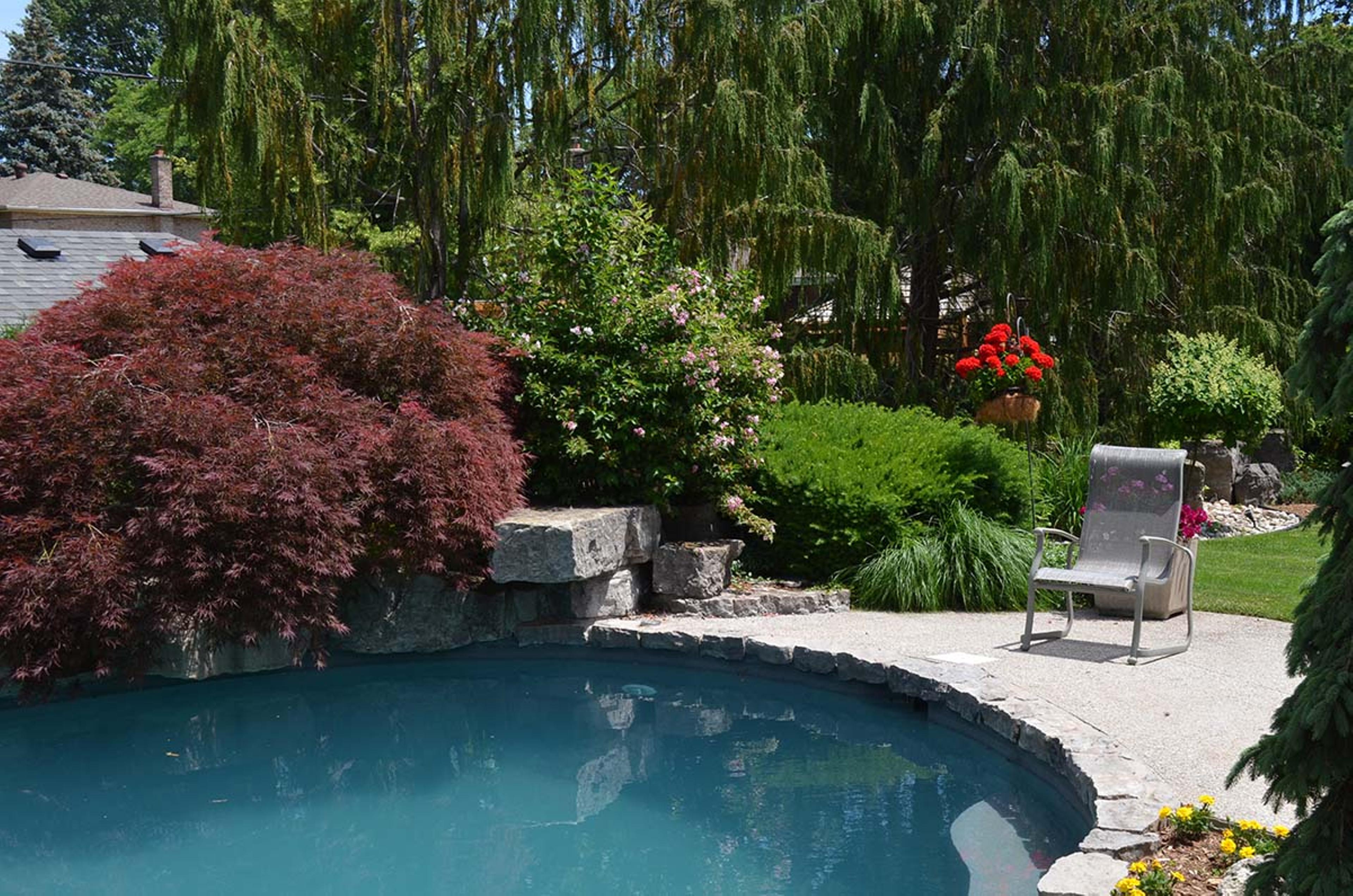 Garden maintenance work by a pool