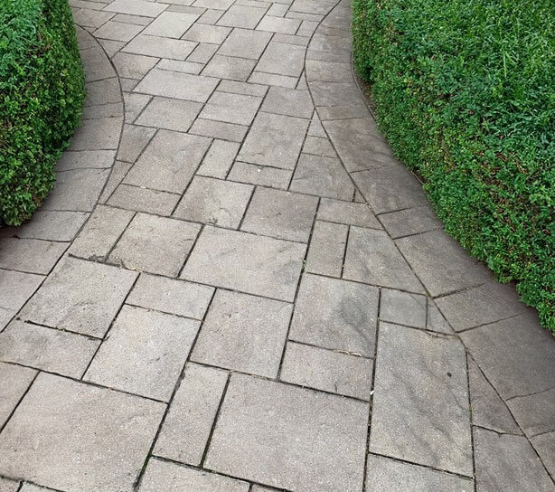 Before and after of sand replacement in patio stone